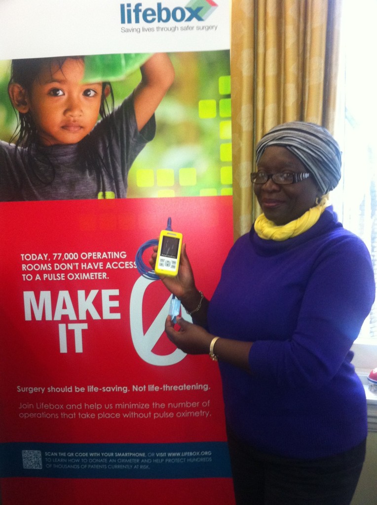 Dr Eva Manciles-Robert demonstrates the pulse oximeter (in colour-coordinated style)